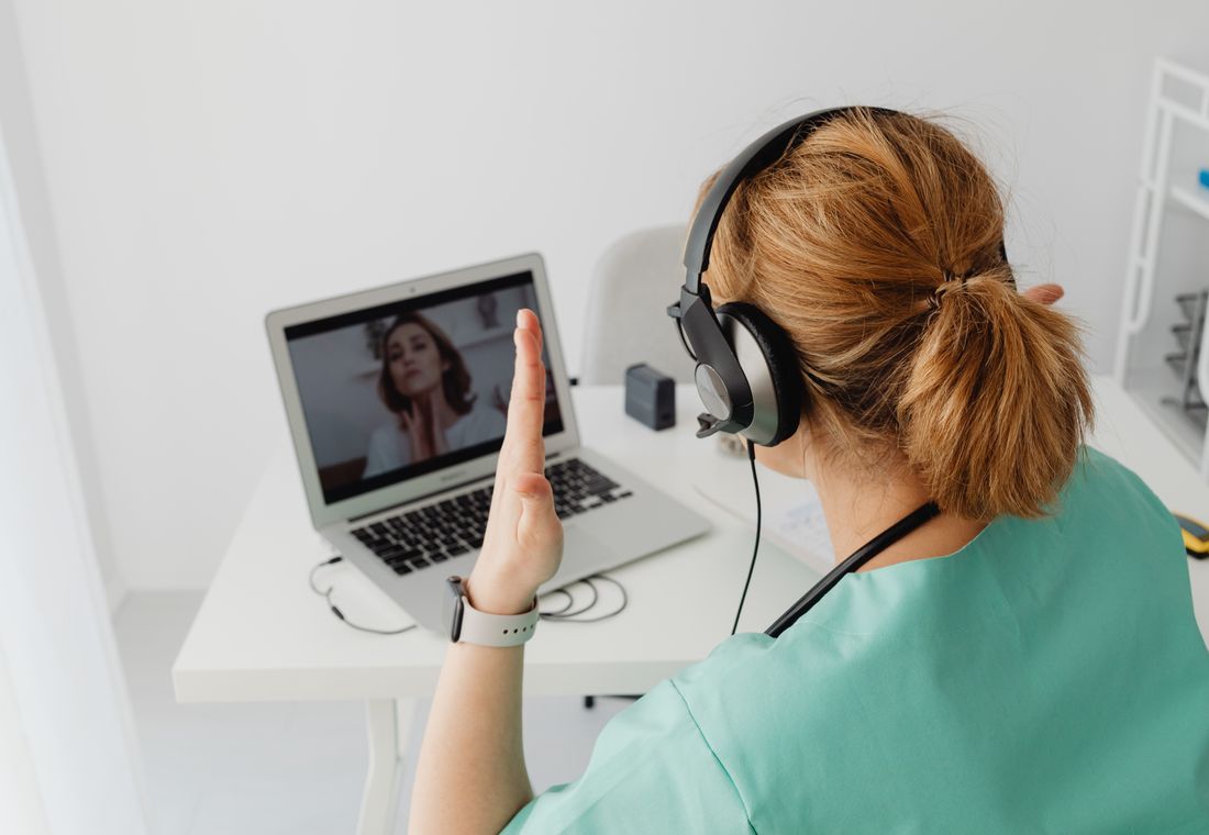 A clinician meeting a patient by secure video
