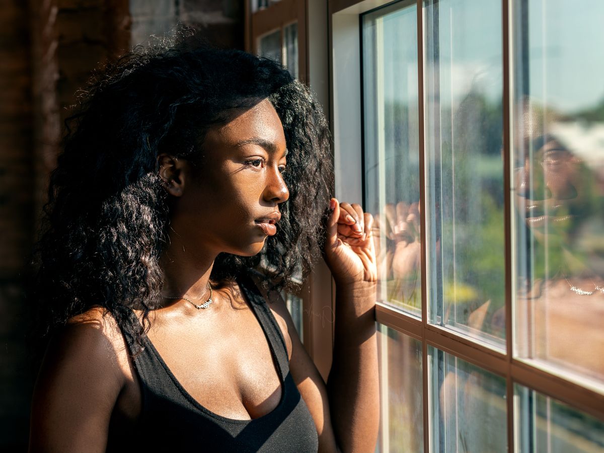 A person in a calm, reflective moment in warm light